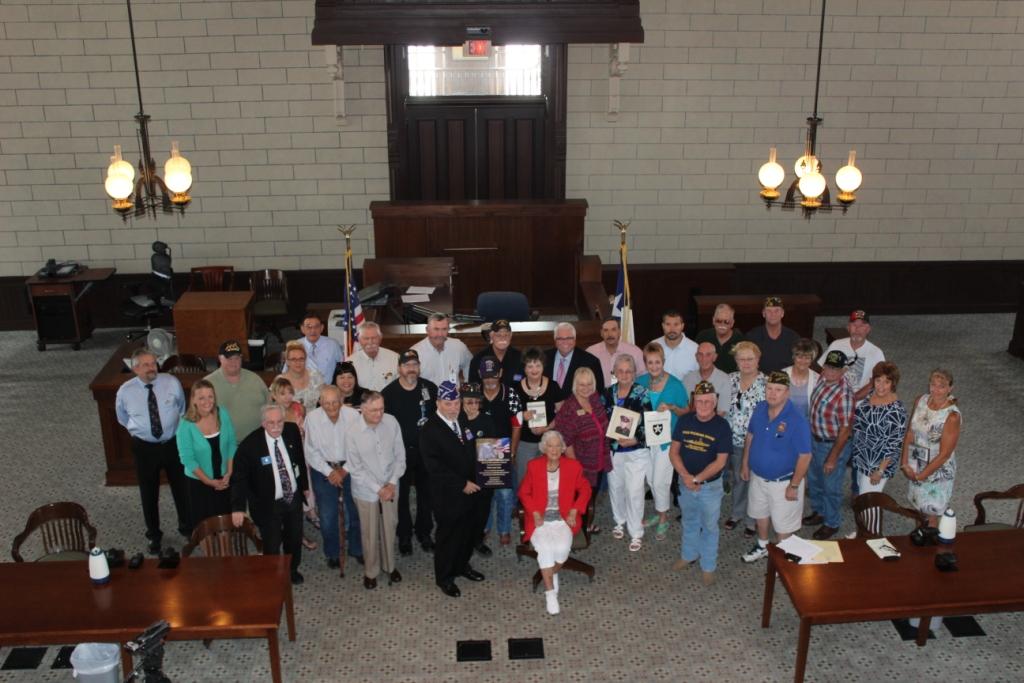 Local Purple Heart recipients and their family members join the Parker County Commissioners Court on July 28, 2014 as Parker County is designated a Purple Heart County.